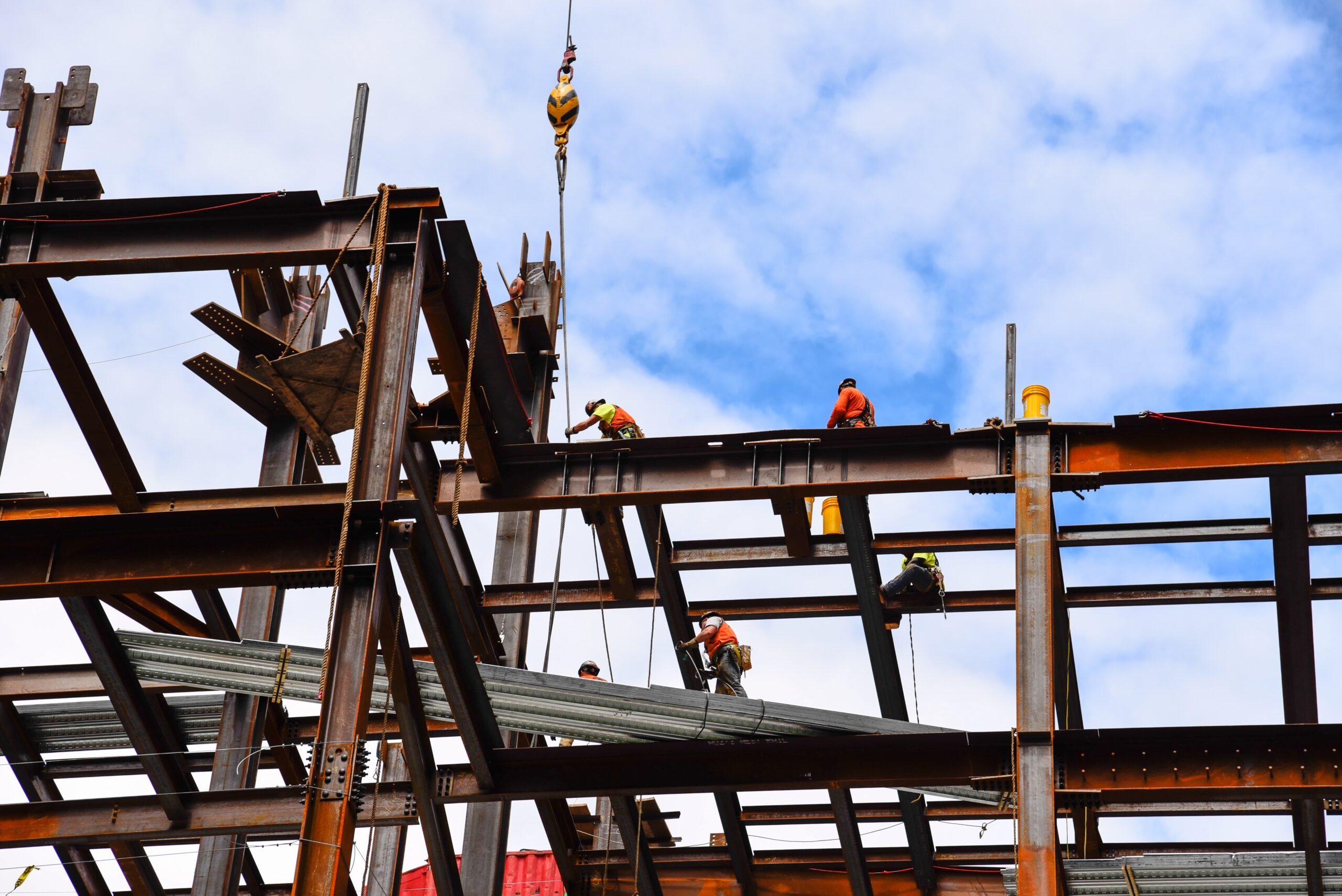 New York City, USA - June 20, 2018: Construction workers on steel beams in construction site of skyscraper in Financial DIstrict